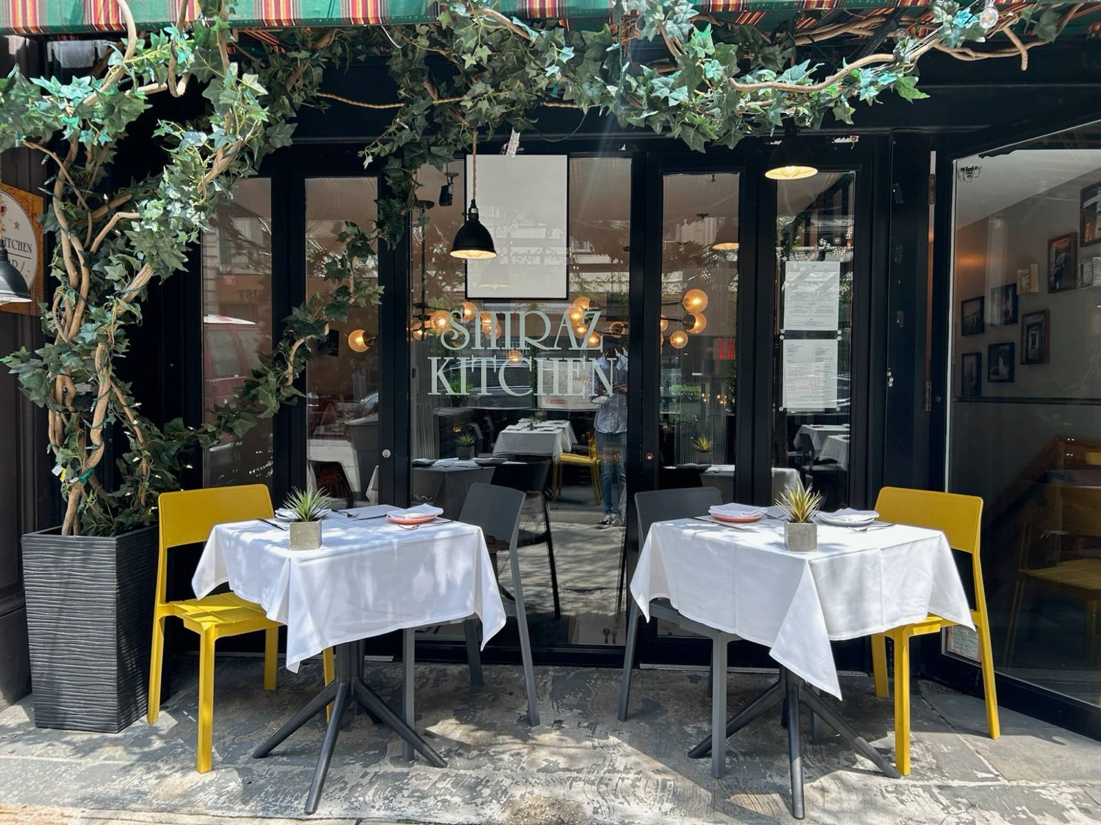 The sidewalk tables under the ivy at Shiraz Kitchen, Chelsea, on West 17th Street