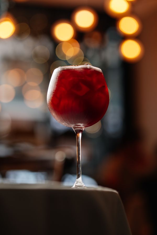 A red cocktail over crushed ice