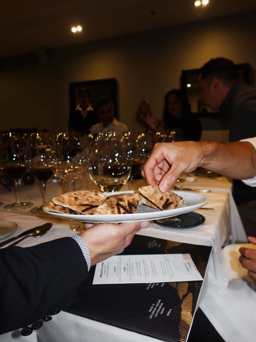 Grilled pita served to guests at a seated dinner