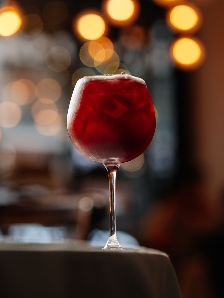 A red cocktail over crushed ice